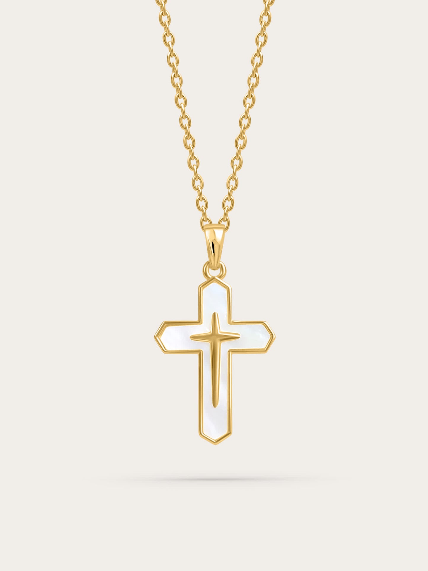Front-facing product image of a gold cross necklace with white enamel inlay on a light background