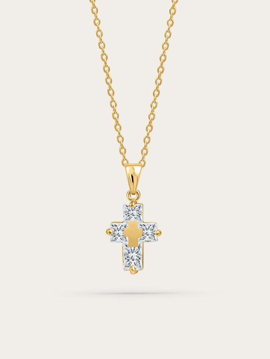 Studio product photo of the Inner Light Crystal Cross Necklace with gold chain and crystal cross pendant on a soft beige background