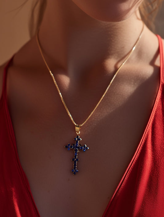 Hand holding the pendant gently, displaying the size and detailing of the cross necklace up close