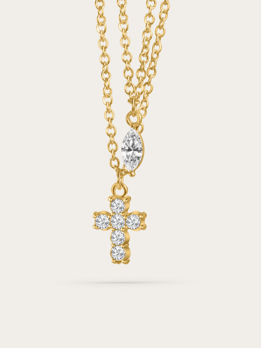 Front-facing studio image of gold double cross necklace with pavé cross and marquise stone pendant on neutral background