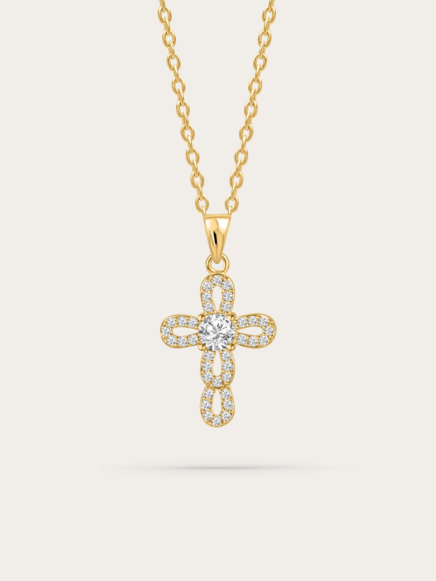 Front view of gold loop cross necklace on white background with radiant center crystal