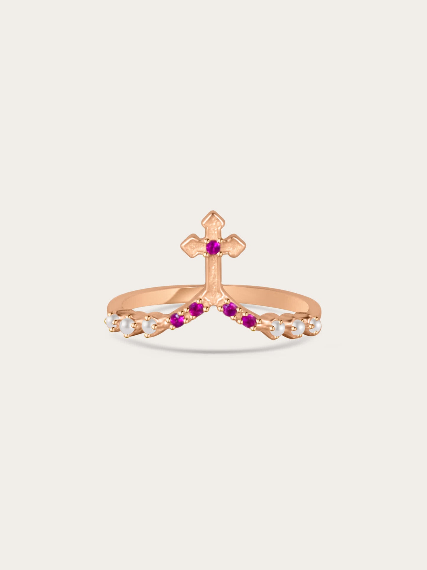 Studio photo of rose gold cross ring with white and pink stones on light background
