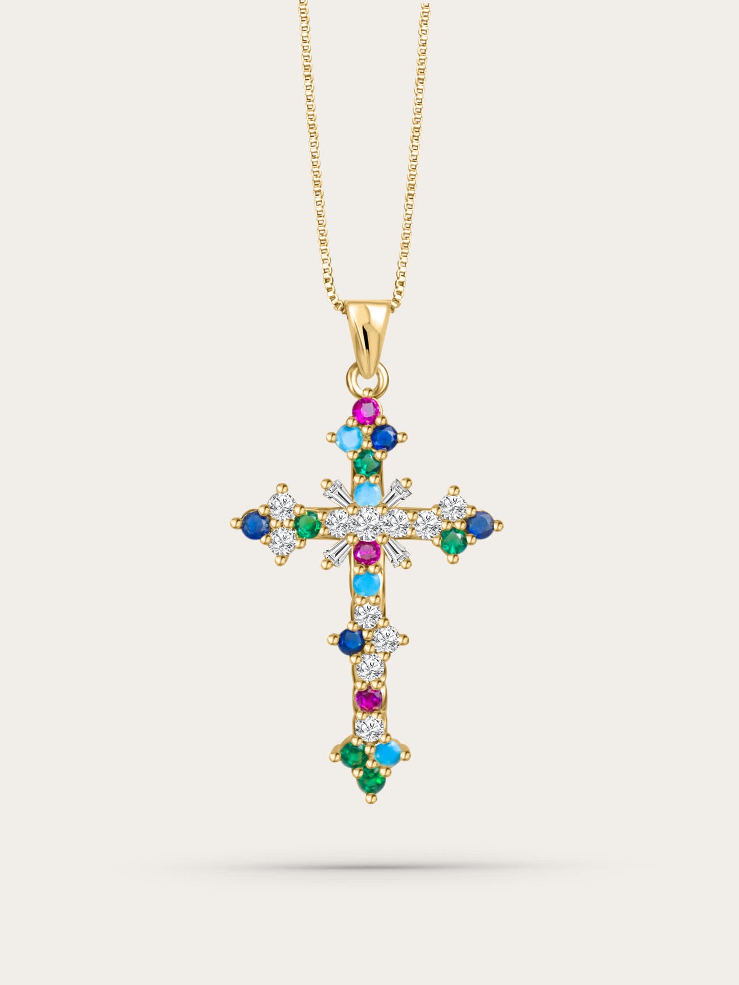 Front-facing studio photo of the colorful crystal cross pendant on light beige background, featuring multicolor zircon stones and gold chain