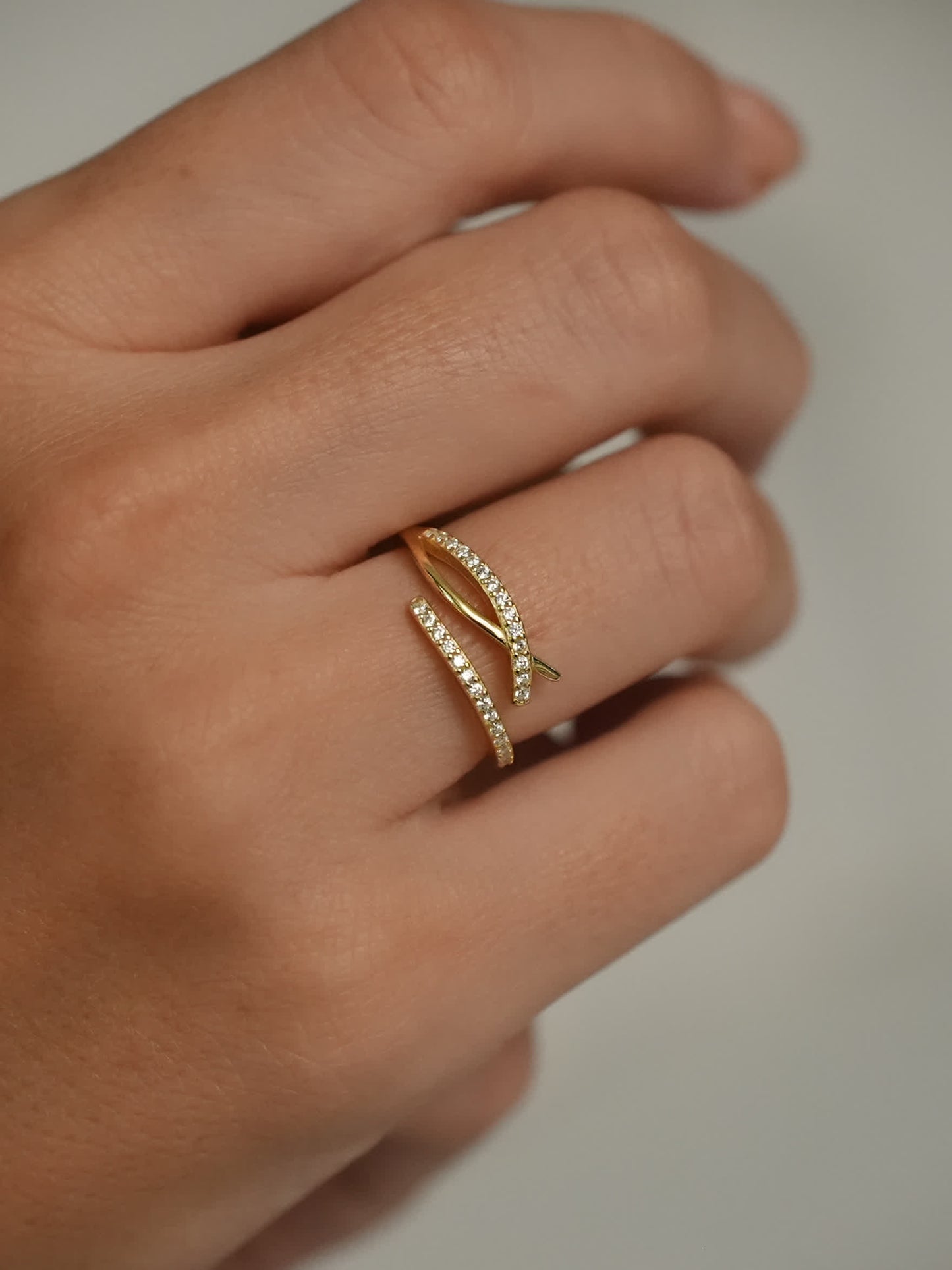 Christian wrap ring worn on finger, highlighting the twin pavé bands and gold-plated 925 silver construction