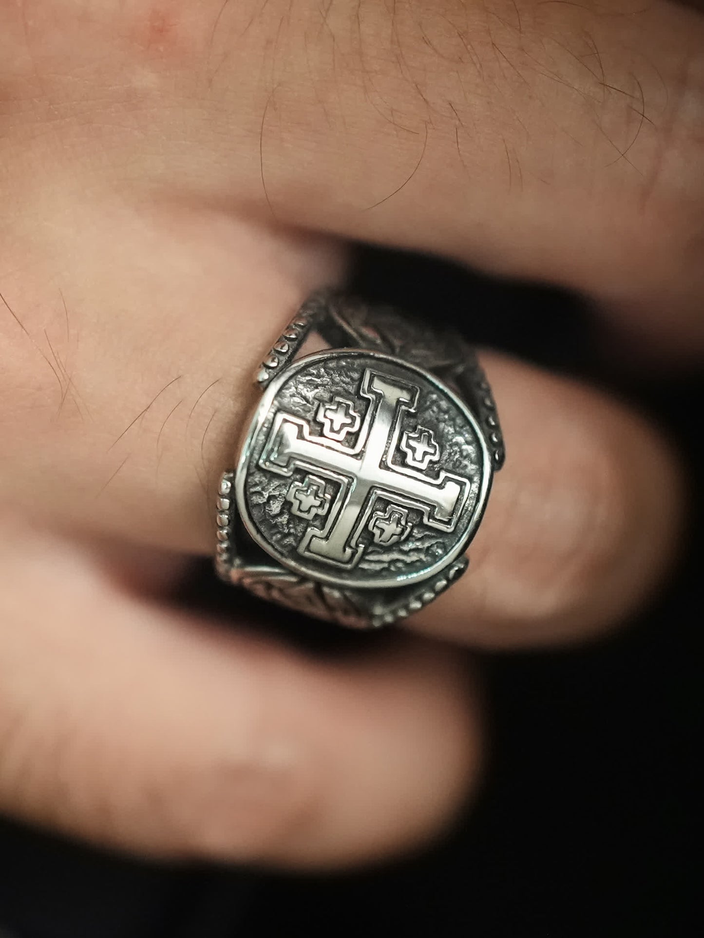 Close-up of the Jerusalem Valor Cross Ring worn on a man’s finger, showing bold and masculine design
