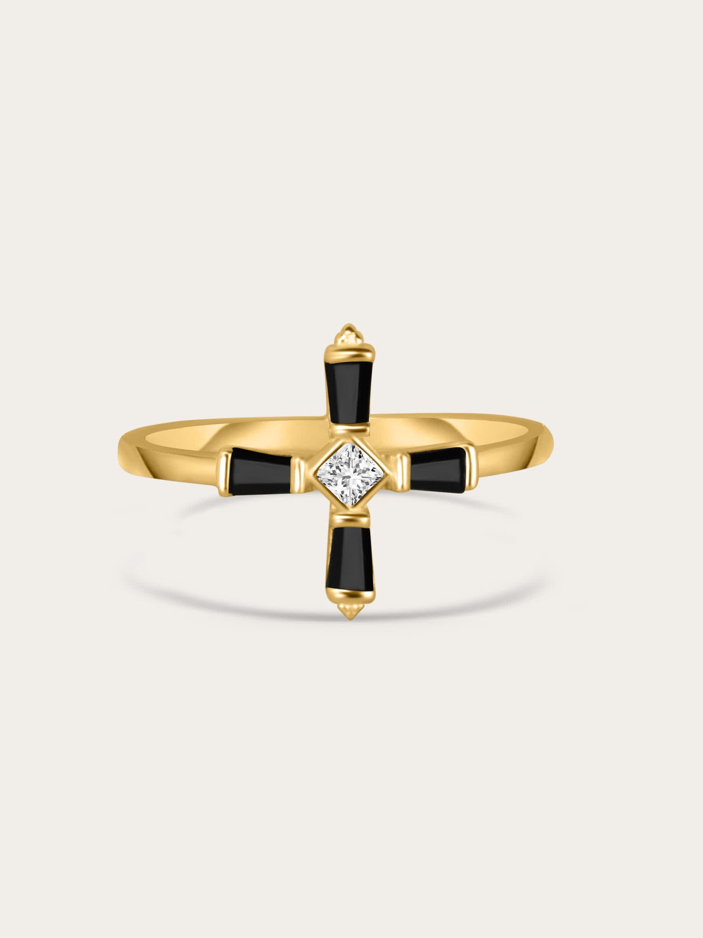 A centered product photo of a gold-plated sterling silver ring featuring a modern black cross design with a central white zircon stone, displayed on a light background.