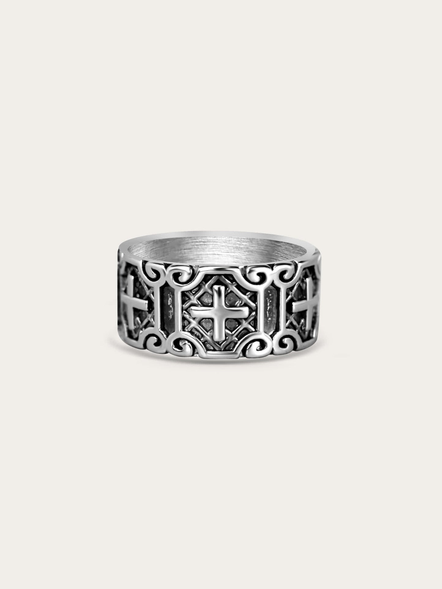 Wide titanium steel cross ring with carved armor pattern on cream background