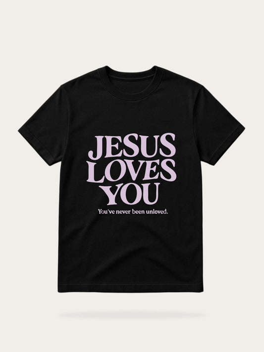 Black t-shirt with 'Jesus Loves You' text on a light gray background