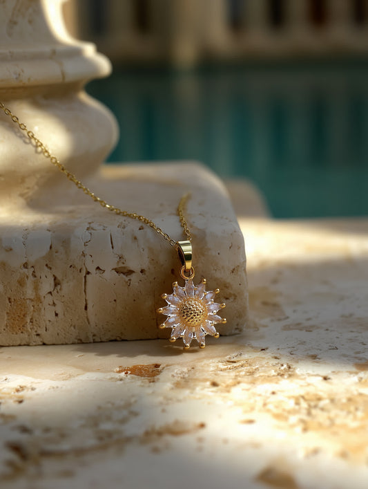 Sunlight Radiance Crystal Blossom Necklace resting on a stone surface near a pool