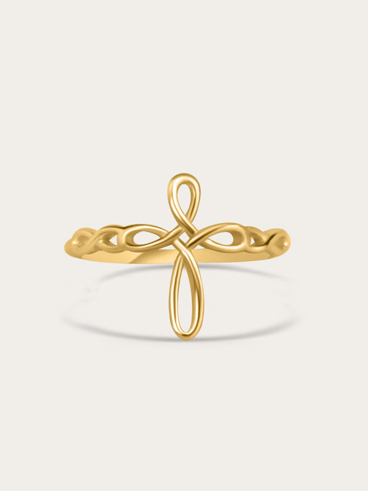 Front-facing studio image of sculptural ribbon-style faith ring in 18K gold plating, centered on light beige background