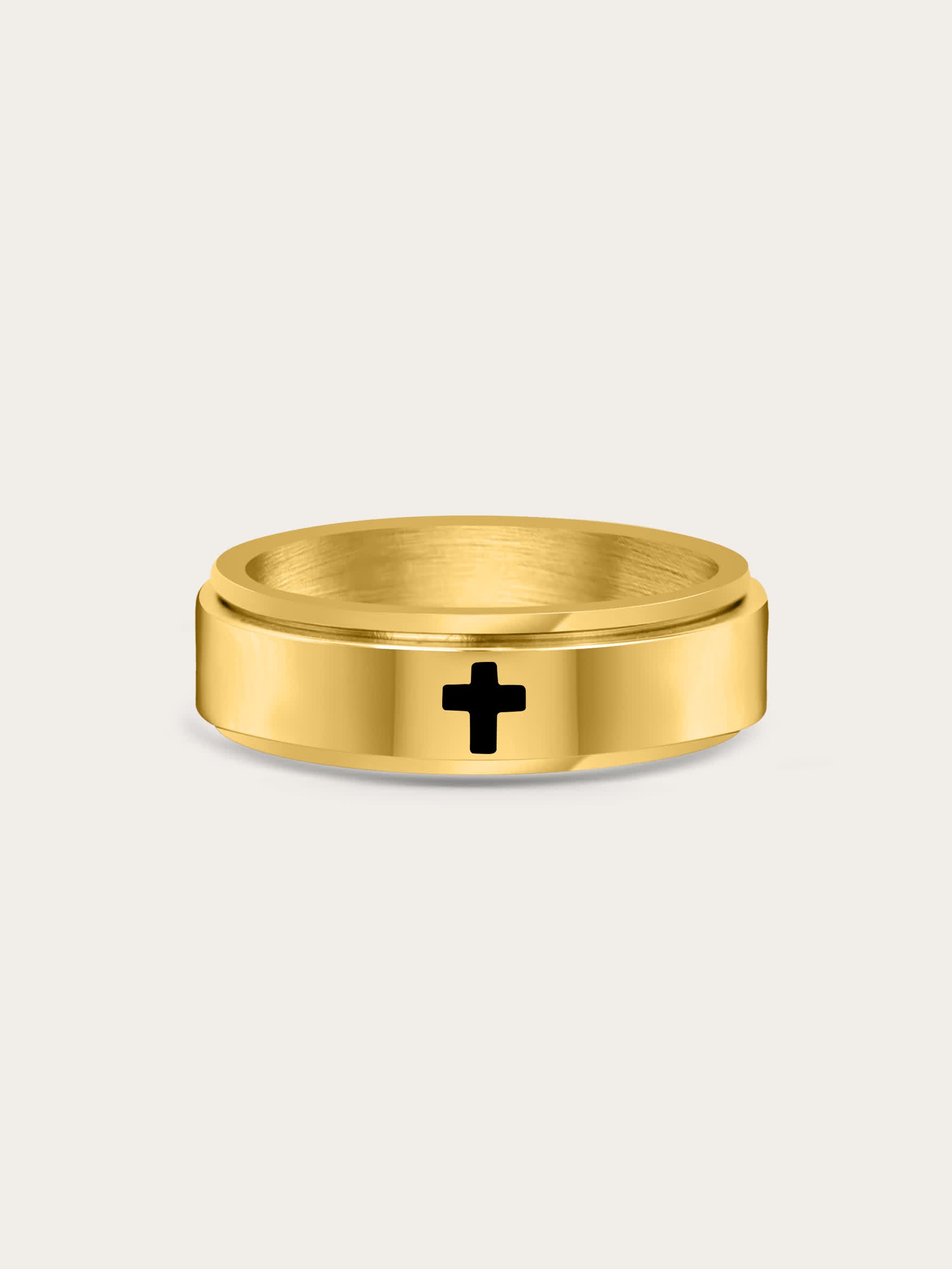 Front-facing image of gold spinner cross ring with engraved black cross on a matte background