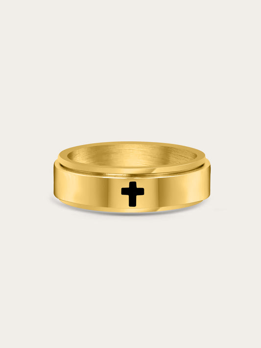 Front-facing image of gold spinner cross ring with engraved black cross on a matte background