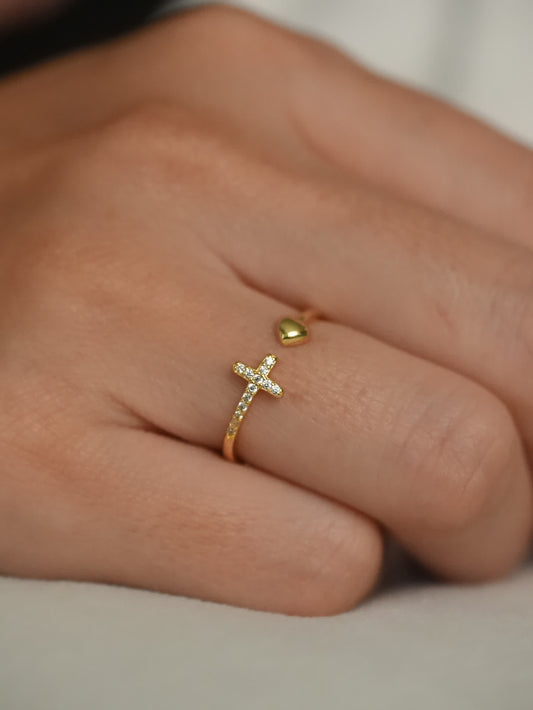 Gold faith ring with pavé cross and heart accent shown on woman’s hand