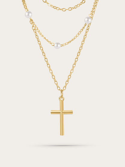 Gold layered cross necklace with freshwater pearls on white background