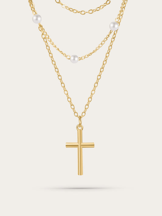 Gold layered cross necklace with freshwater pearls on white background