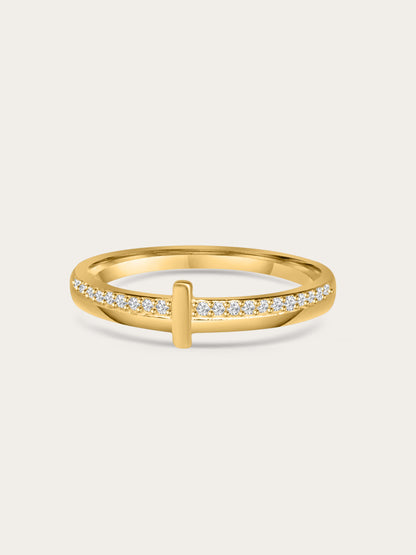 Close-up of gold thin cross ring with pavé cubic zirconia on a neutral background