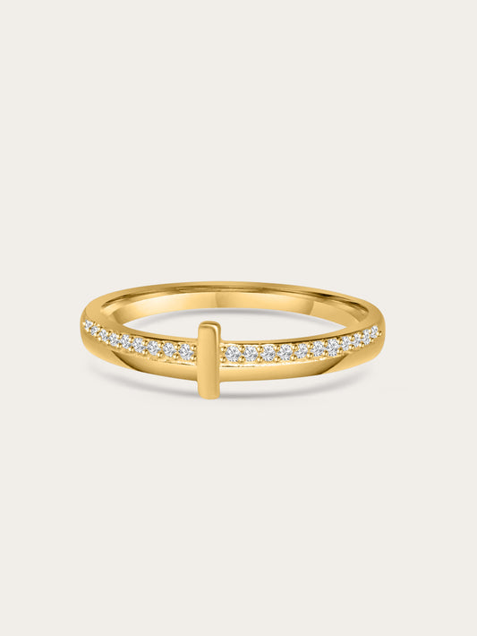 Close-up of gold thin cross ring with pavé cubic zirconia on a neutral background