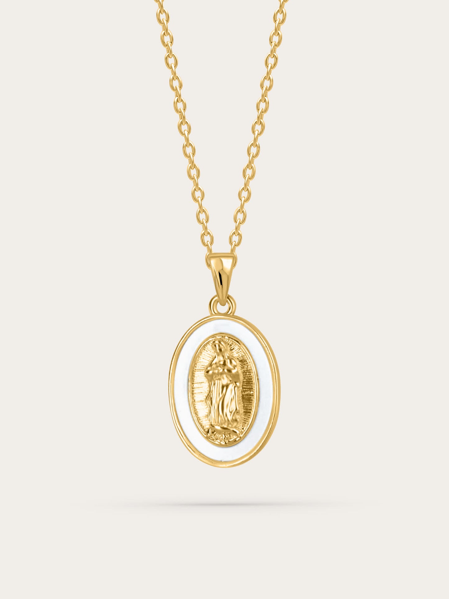 Front-facing product image of the Madonna shell medal necklace featuring a gold-plated Virgin Mary oval pendant with white shell border on a simple gold chain, against a neutral background.


