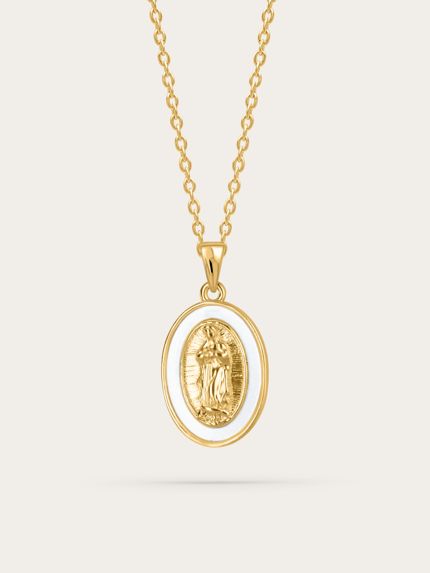 Front-facing product image of the Madonna shell medal necklace featuring a gold-plated Virgin Mary oval pendant with white shell border on a simple gold chain, against a neutral background.

