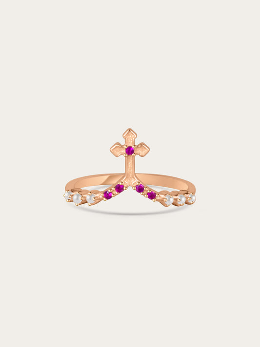 Studio photo of rose gold cross ring with white and pink stones on light background