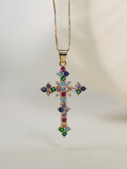 Pendant displayed upright on neutral background with soft lighting, highlighting gold setting and multicolor crystal arrangement