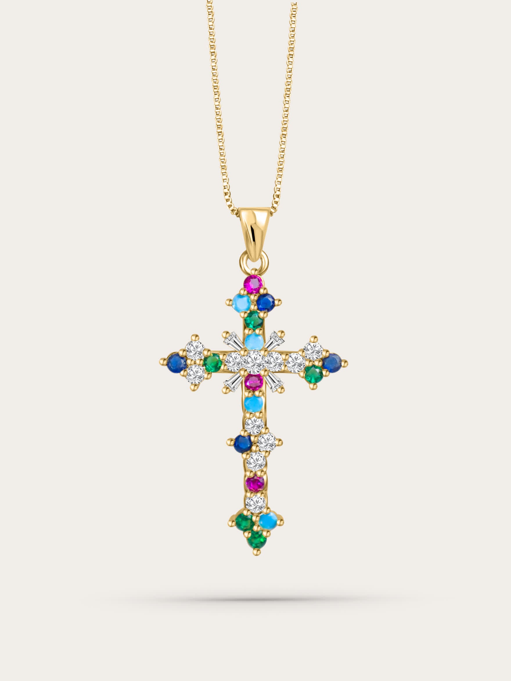 Front-facing studio photo of the colorful crystal cross pendant on light beige background, featuring multicolor zircon stones and gold chain