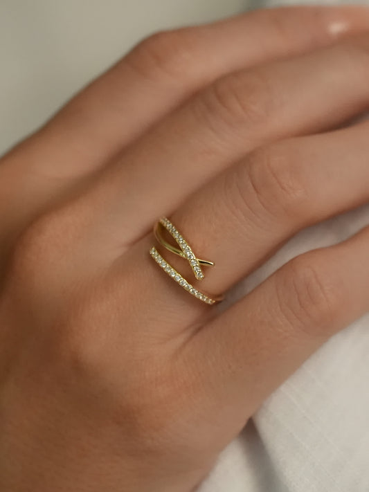 Ichthys-inspired gold cross ring worn on hand, showcasing its elegant wrap design and crystal sparkle