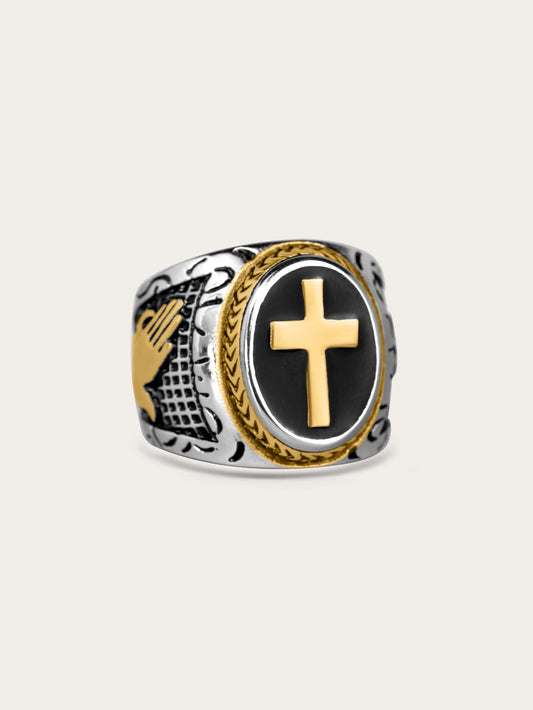 Side-angle view of the gold cross men’s ring resting on a neutral cream background