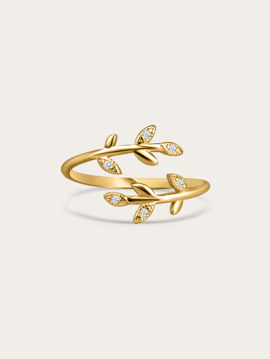 Gold olive branch ring with cubic zirconia leaves displayed on white background
