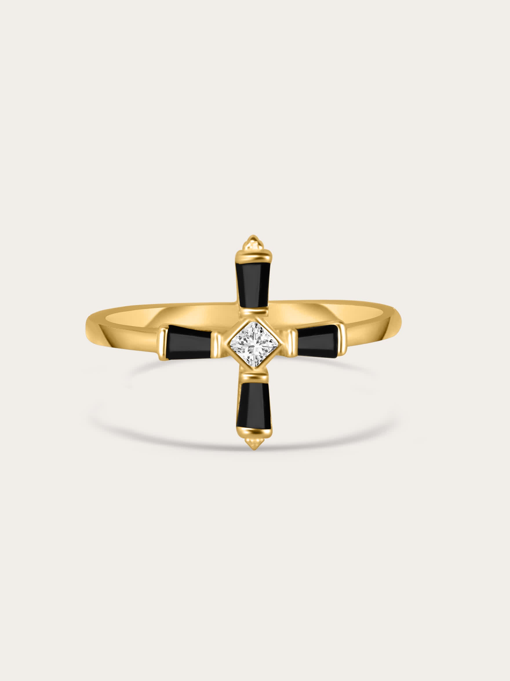 A centered product photo of a gold-plated sterling silver ring featuring a modern black cross design with a central white zircon stone, displayed on a light background.