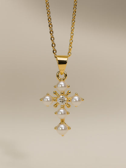 Delicate gold cross necklace with white pearls and flower-inspired design