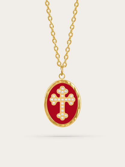 Crimson enamel cross pendant with pearl-accented gold cross on neutral background