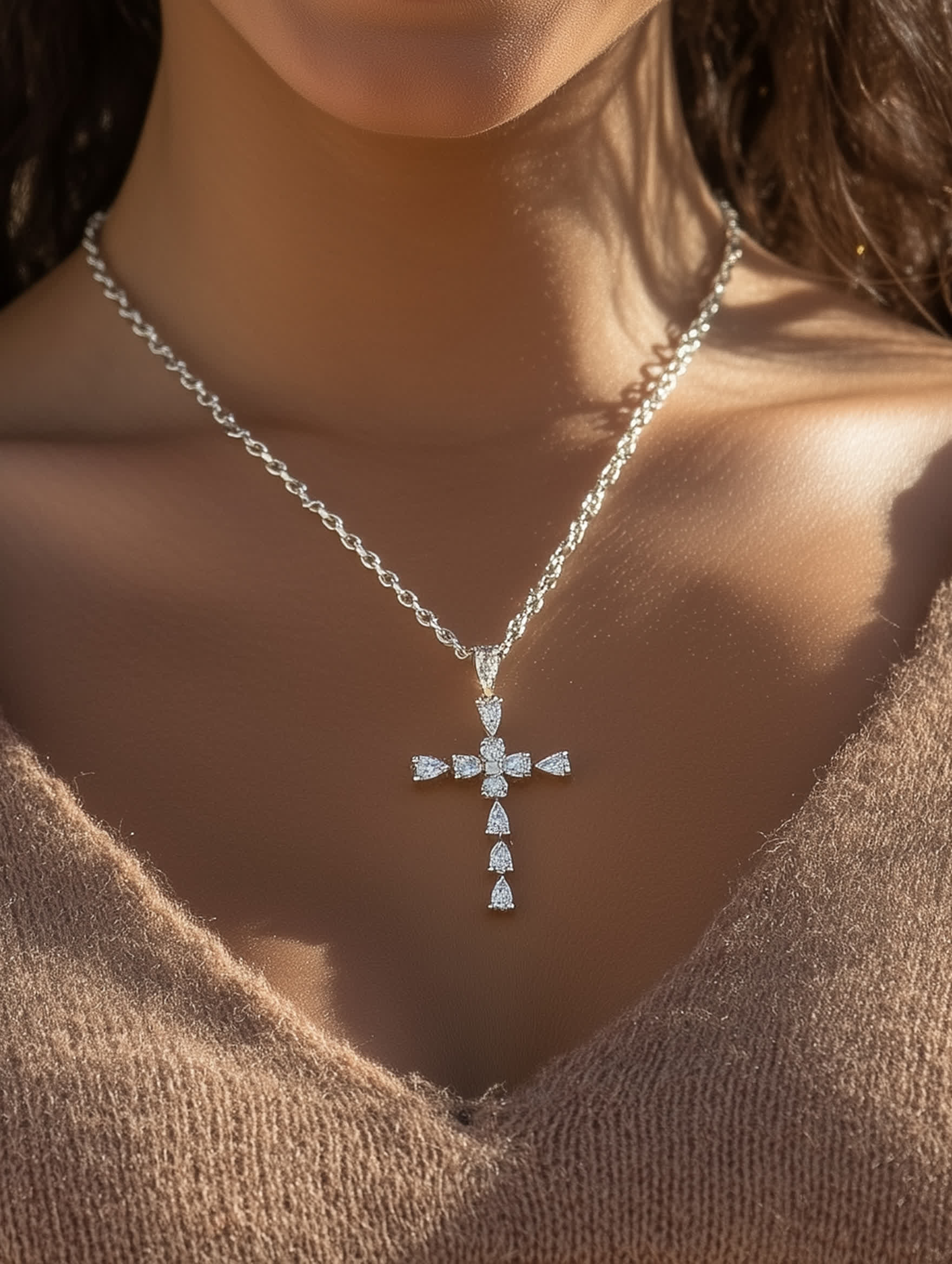 Woman wearing the Christian crystal cross necklace, highlighting its elegant placement and shimmer