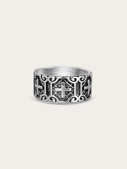 Wide titanium steel cross ring with carved armor pattern on cream background