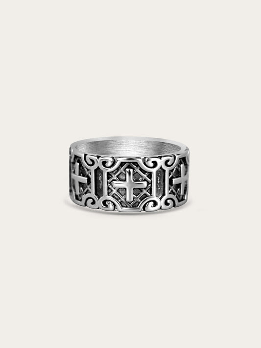Wide titanium steel cross ring with carved armor pattern on cream background