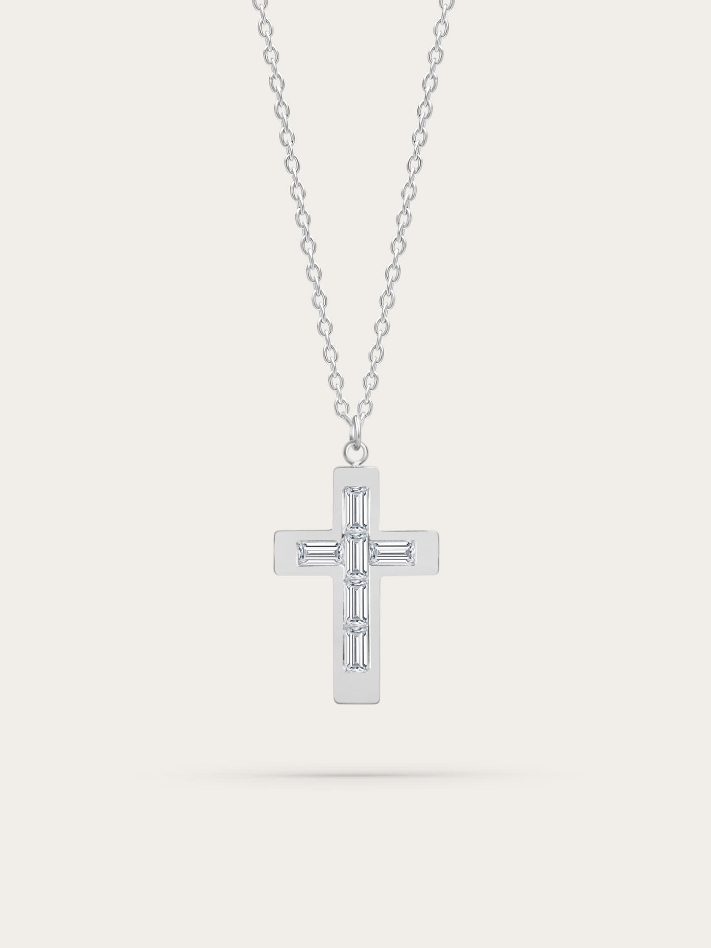 Silver stainless steel cross necklace with baguette-cut zircons on light background