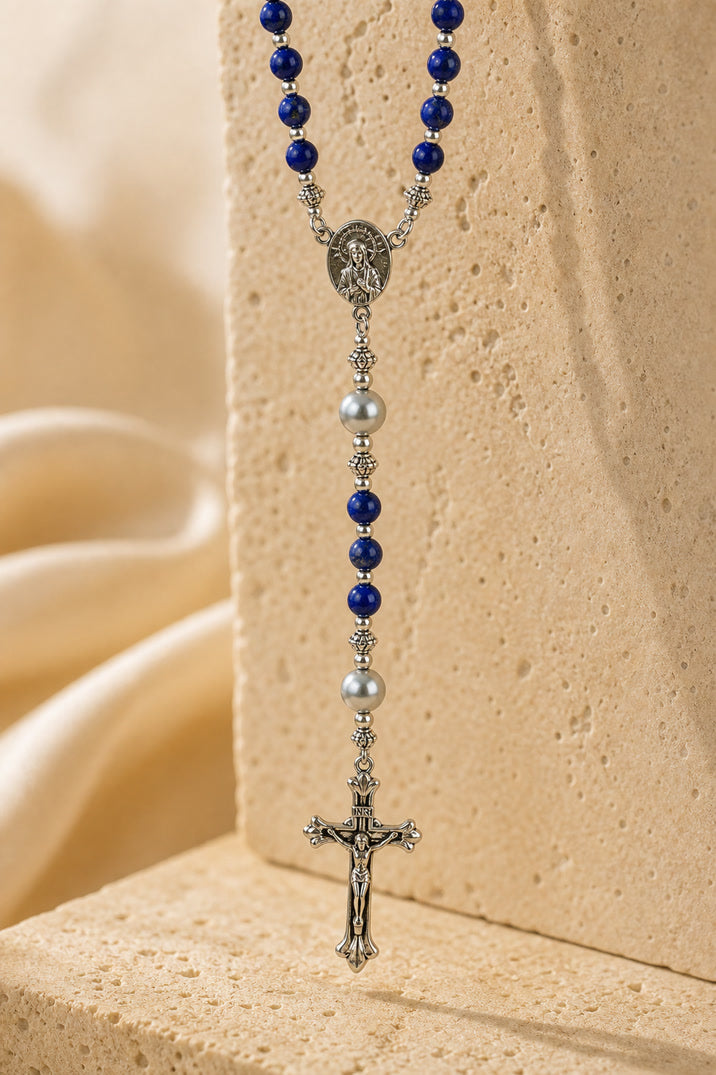 Rosary with blue and silver beads on a beige background