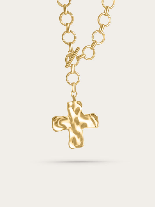 Chunky gold hammered cross necklace with toggle clasp and oversized chain links, product shot on white background