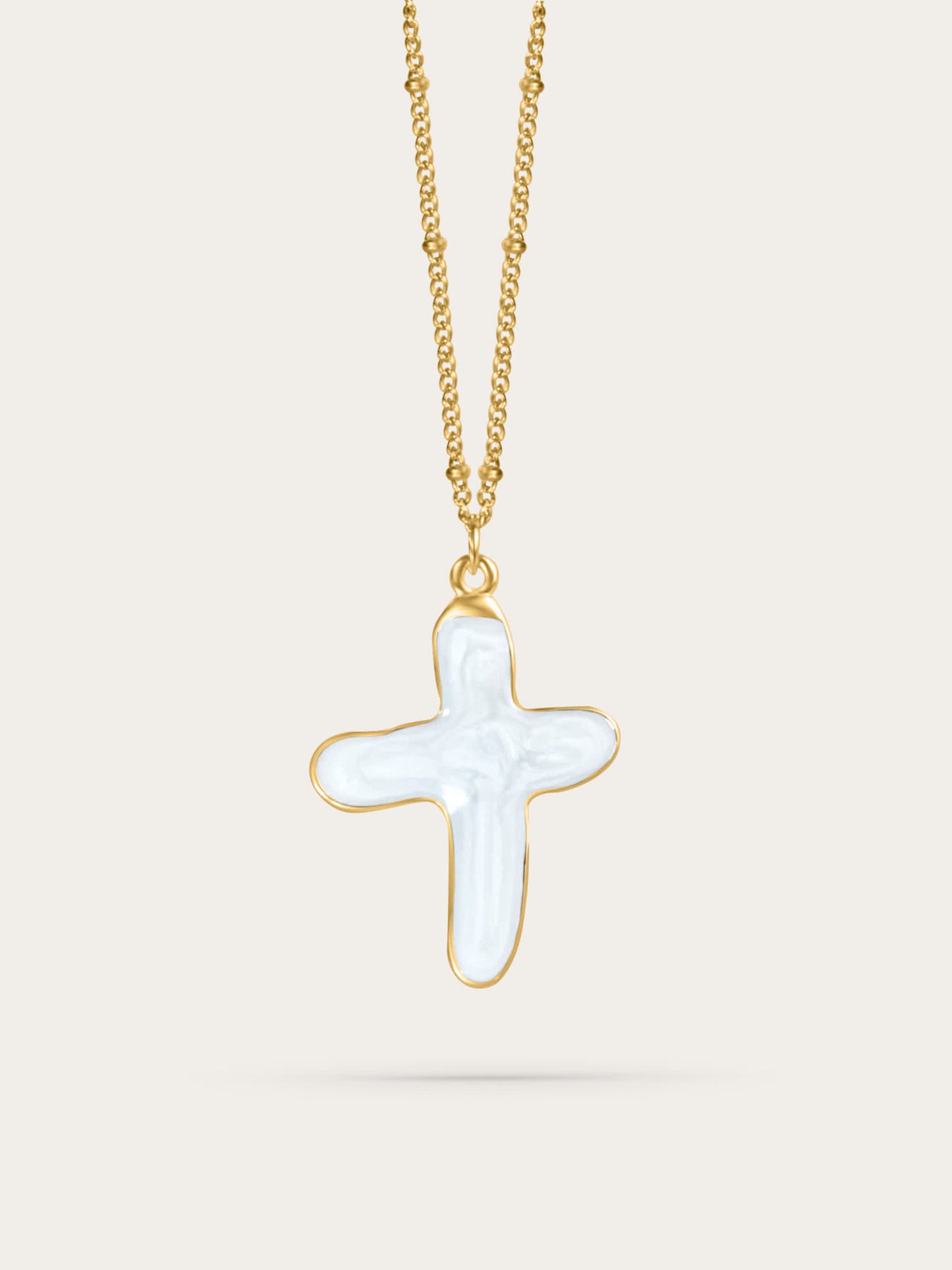 White shell cross pendant necklace in 14k gold vermeil, suspended mid-air on a neutral background – elegant Christian jewelry design.